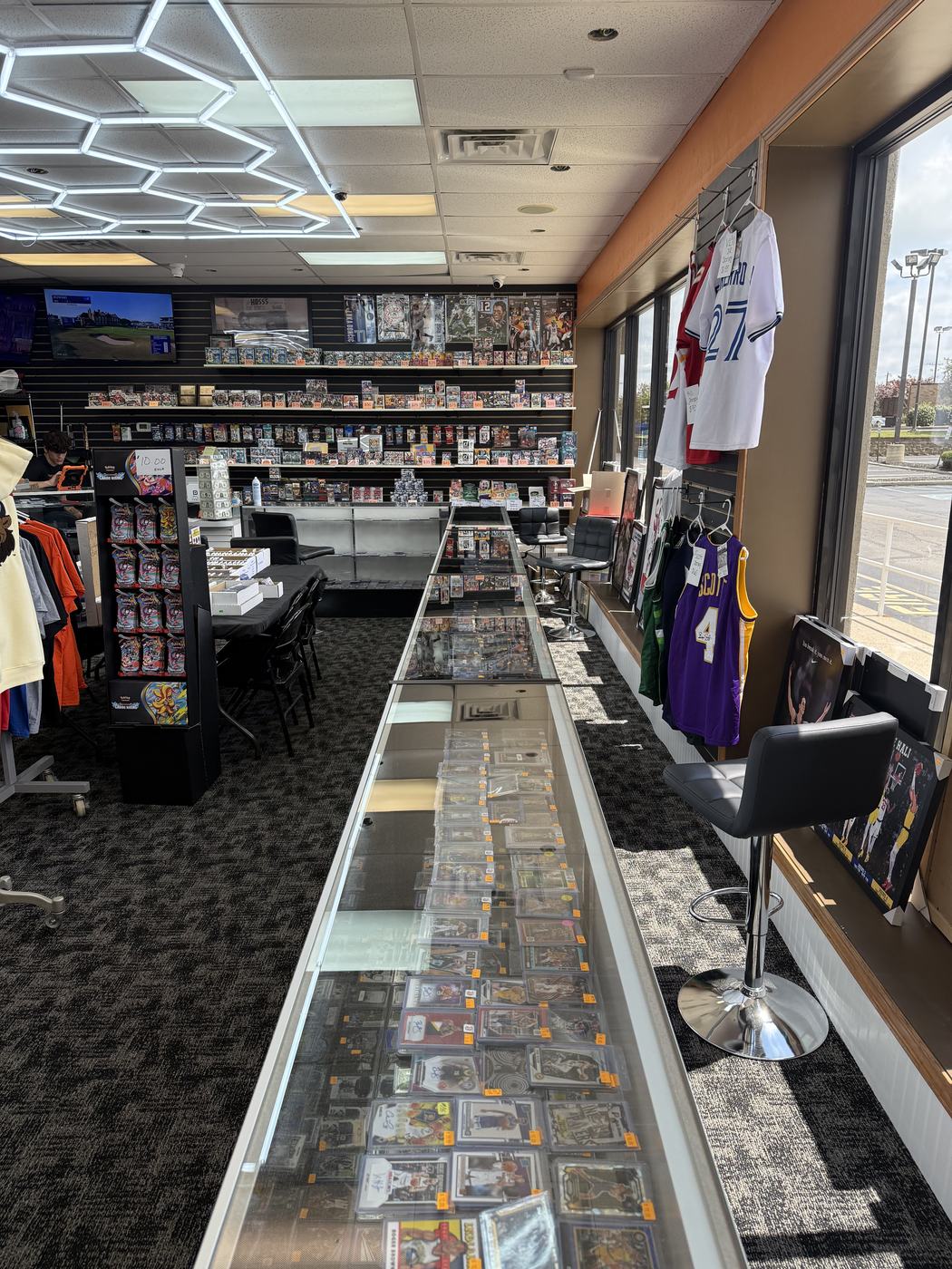 The card room with hex lighting, a long glass showcase and a wall of sealed wax