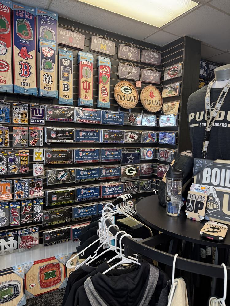 Fan cave corner with barrel signs, license plate frames and Purdue gear
