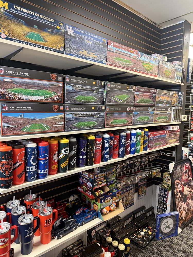 Panoramic stadium puzzles and team water bottles on shelves